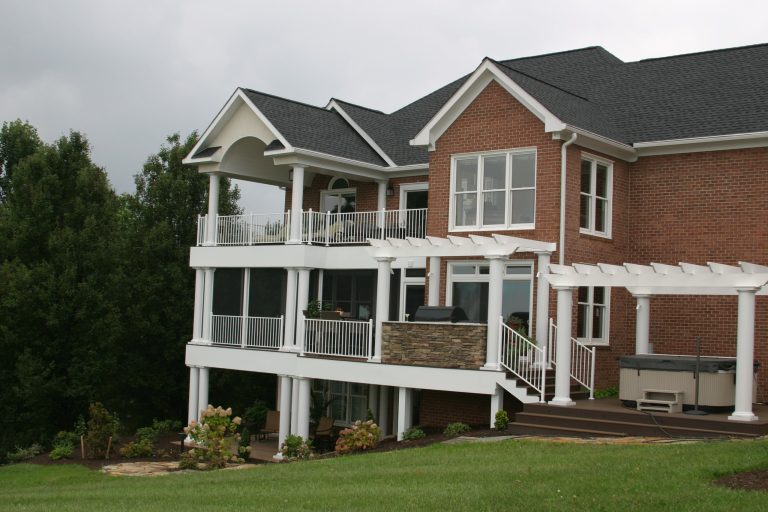 Example of a large classic backyard outdoor kitchen deck design in Other with a pergola