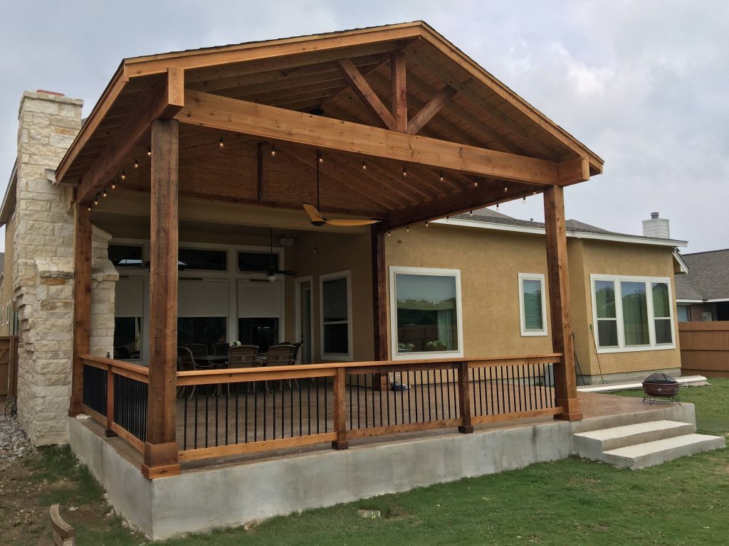 Example of a large classic backyard outdoor kitchen deck design in Other with a roof extension