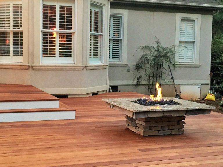 Example of a large classic backyard patio kitchen design in Charlotte with decking and a pergola