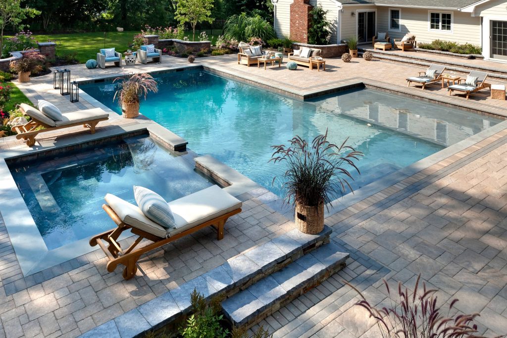 Example of a large classic backyard stone and custom-shaped lap hot tub design in Philadelphia