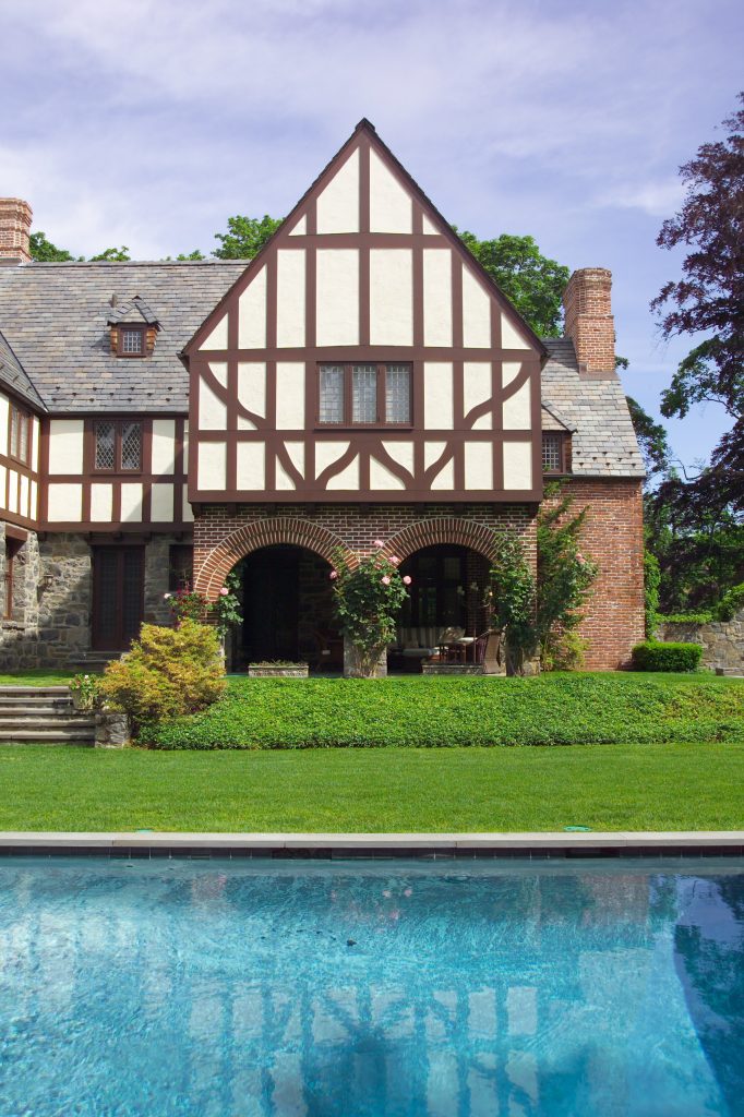 Example of a large classic backyard stone and rectangular hot tub design in New York