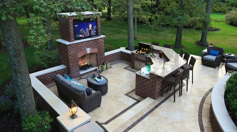 Example of a large classic backyard stone patio kitchen design in Columbus with no cover
