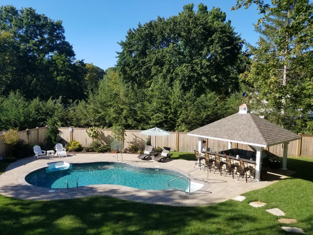 Example of a large classic backyard stone patio kitchen design in Philadelphia with a gazebo