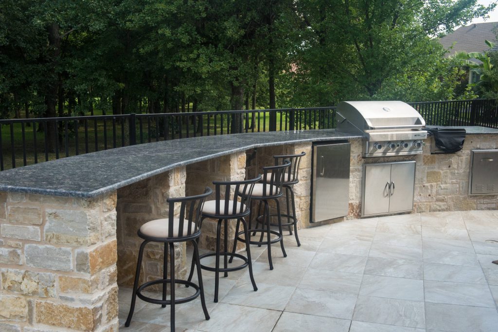 Example of a large classic backyard tile patio kitchen design in Dallas with no cover