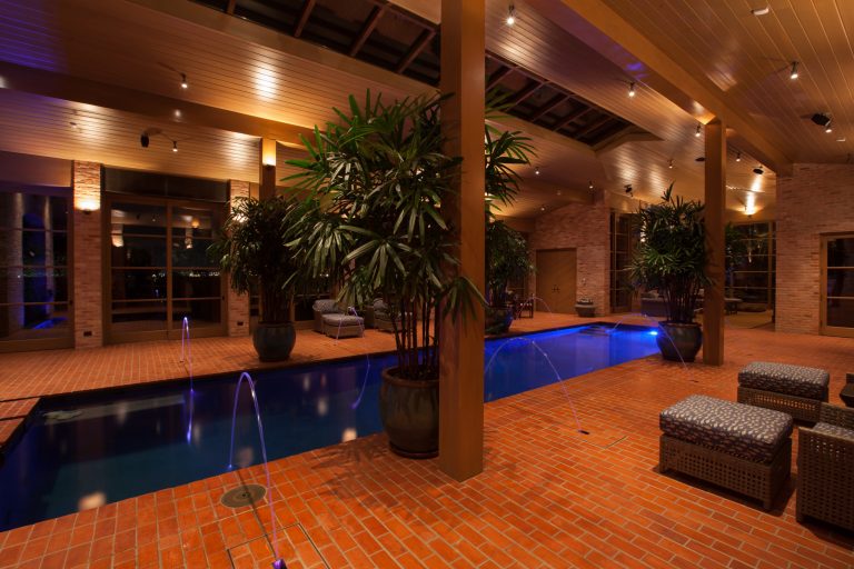 Example of a large classic indoor rectangular and brick pool fountain design in Austin