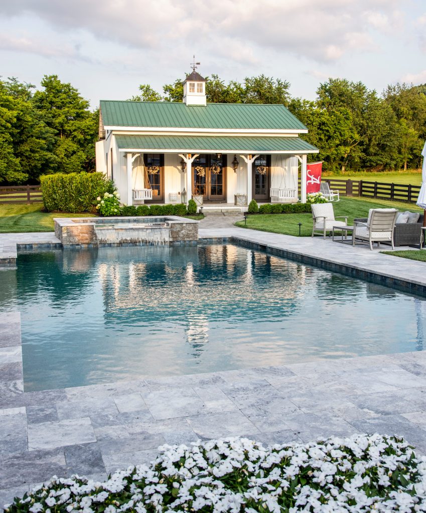 Example of a large cottage backyard stone and custom-shaped pool design in Nashville