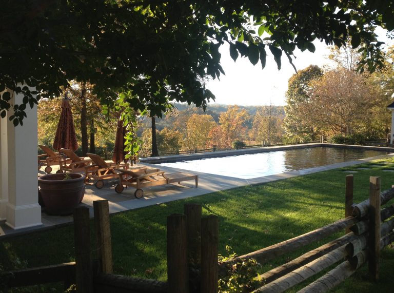 Example of a large cottage backyard stone and rectangular lap pool design in DC Metro