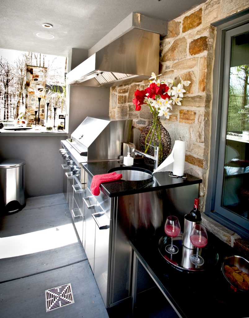 Example of a large eclectic backyard concrete patio kitchen design in Baltimore with a roof extension