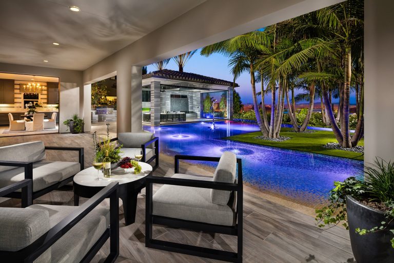 Example of a large island style backyard tile and l-shaped infinity pool house design in San Diego