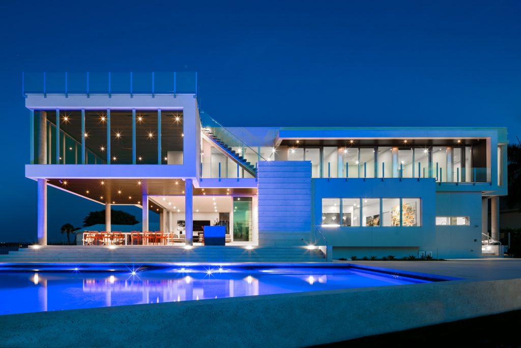 Example of a large minimalist backyard concrete and custom-shaped aboveground pool design in Tampa