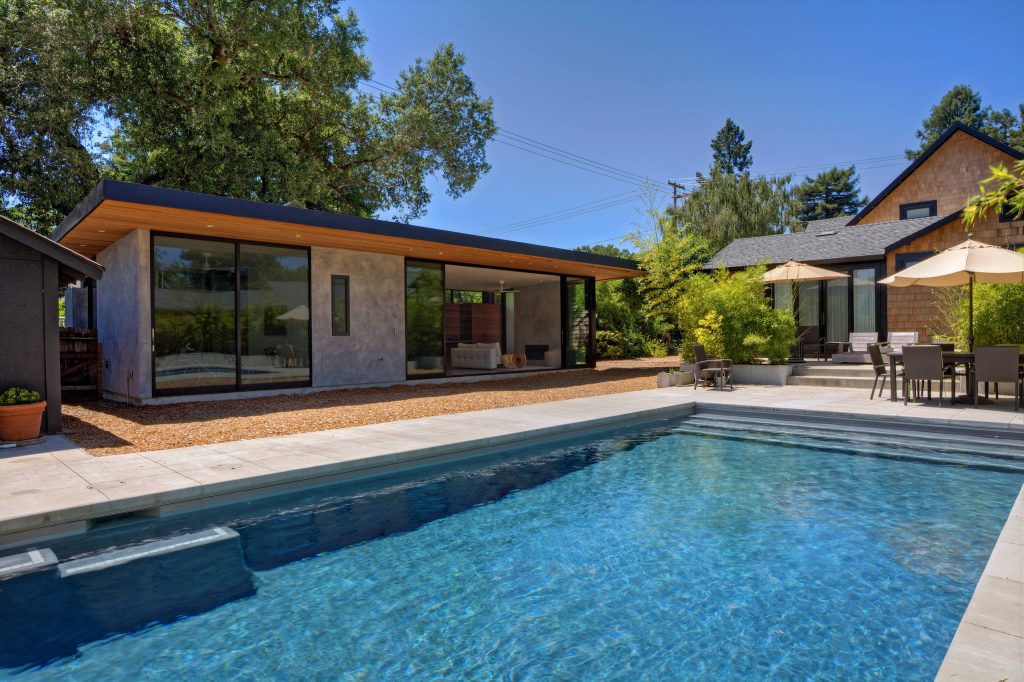 Example of a large minimalist backyard concrete paver and rectangular lap pool design in San Francisco