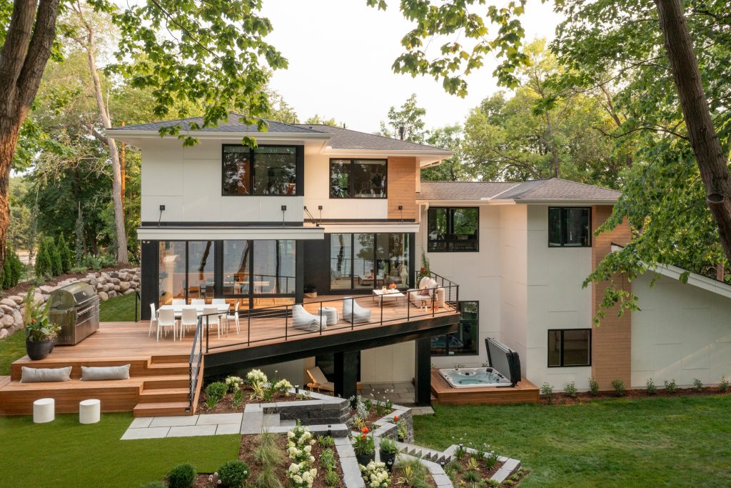 Example of a large minimalist backyard patio kitchen design in Minneapolis with decking and no cover