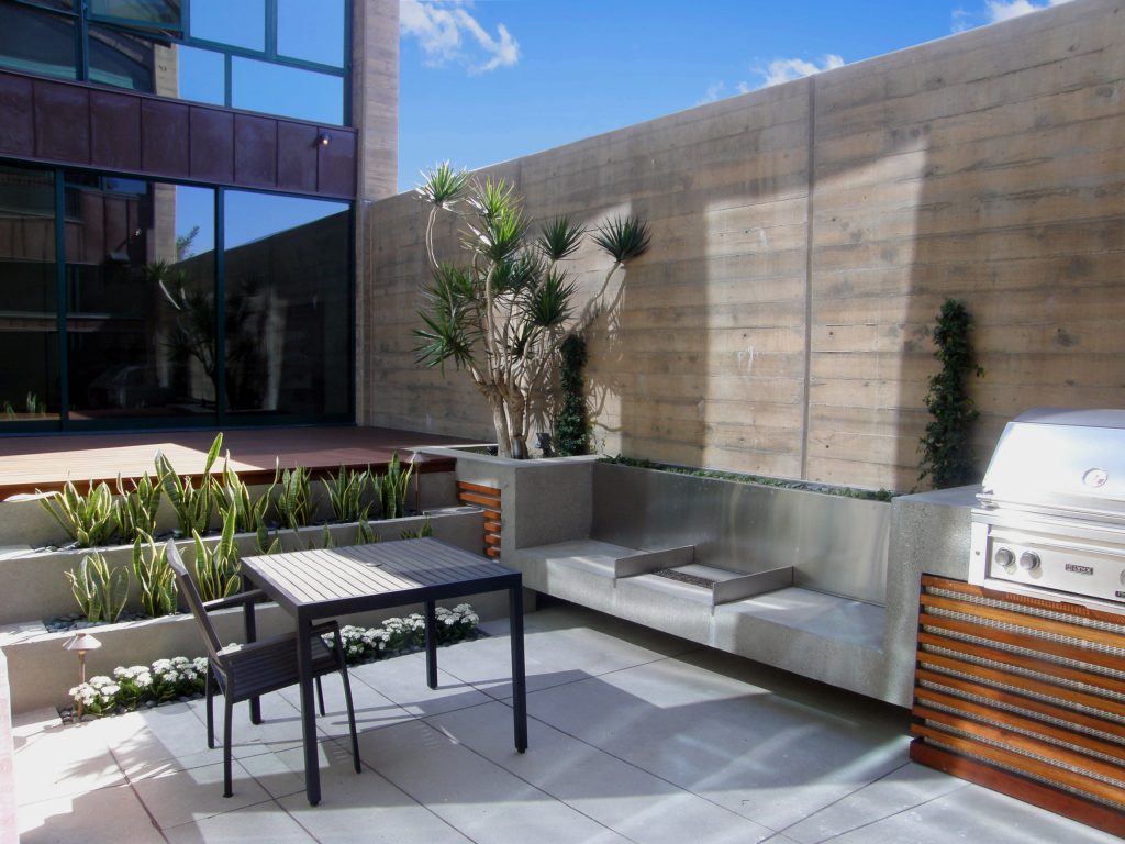 Example of a large minimalist backyard tile patio kitchen design in San Diego with no cover