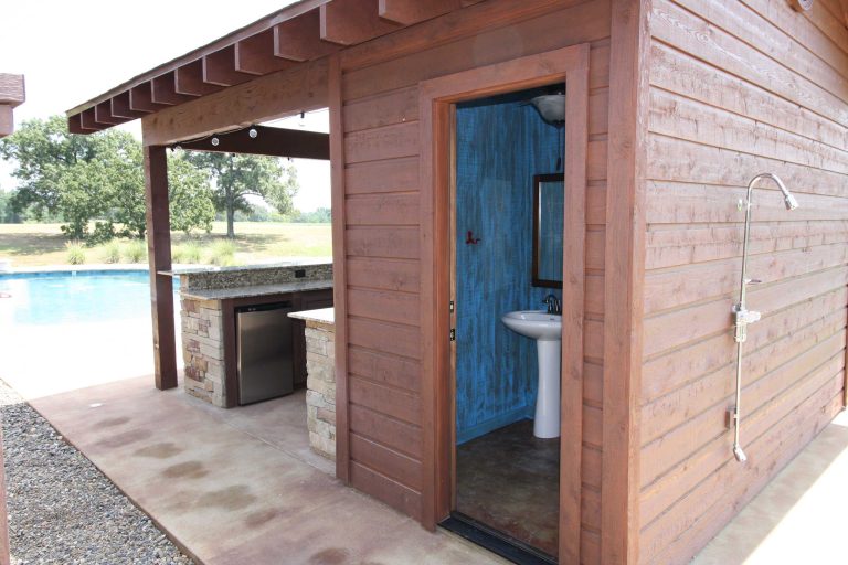 Example of a large mountain style backyard stone patio kitchen design in New Orleans with a gazebo