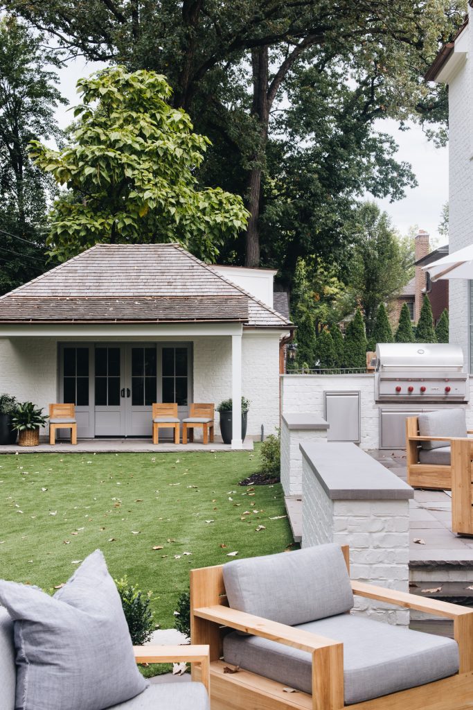 Example of a large transitional backyard brick patio kitchen design in Chicago with no cover