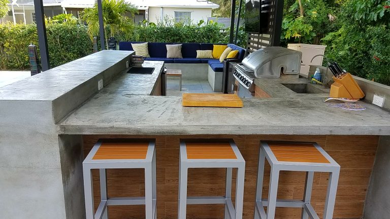 Example of a large transitional backyard concrete patio kitchen design in Miami with a pergola
