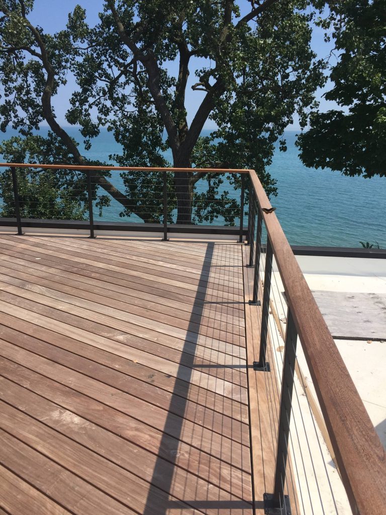 Example of a large transitional backyard deck design in Chicago with no cover