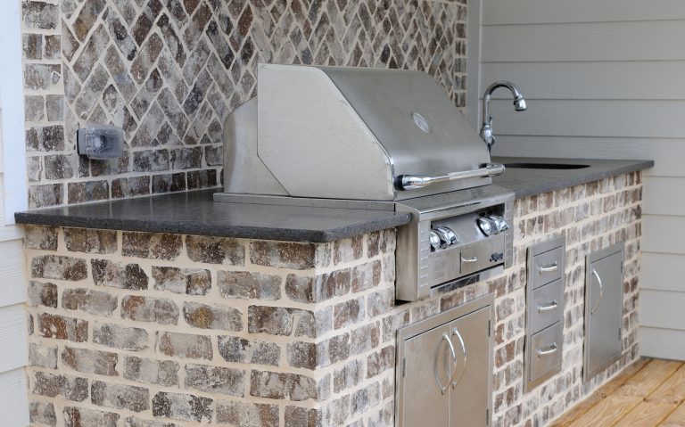 Example of a large transitional backyard patio kitchen design in Atlanta with decking and a roof extension
