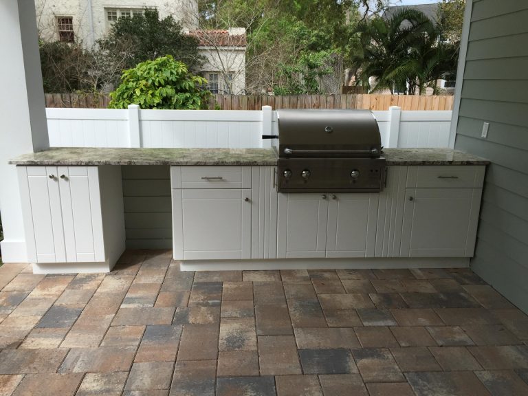 Example of a large transitional backyard patio kitchen design in Tampa with a roof extension