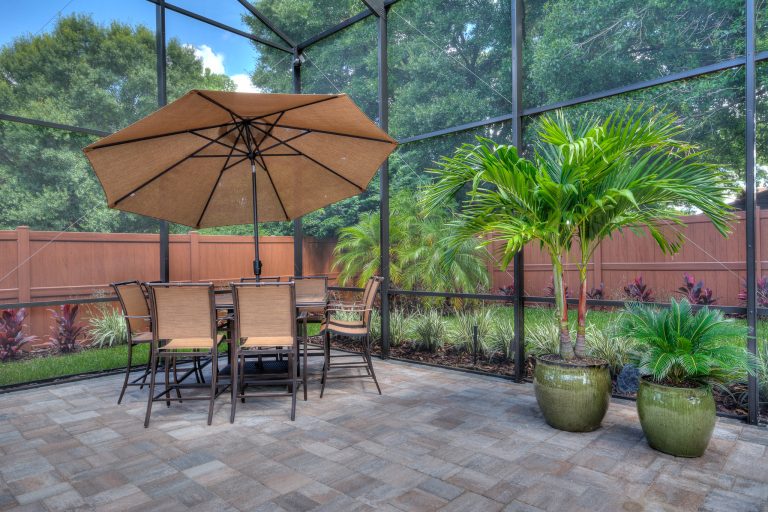 Example of a large transitional backyard stone and custom-shaped lap hot tub design in Orlando