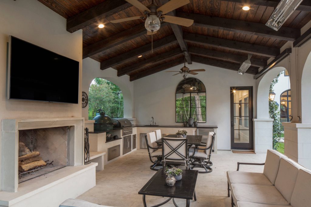 Example of a large transitional backyard tile patio kitchen design in Austin with a roof extension