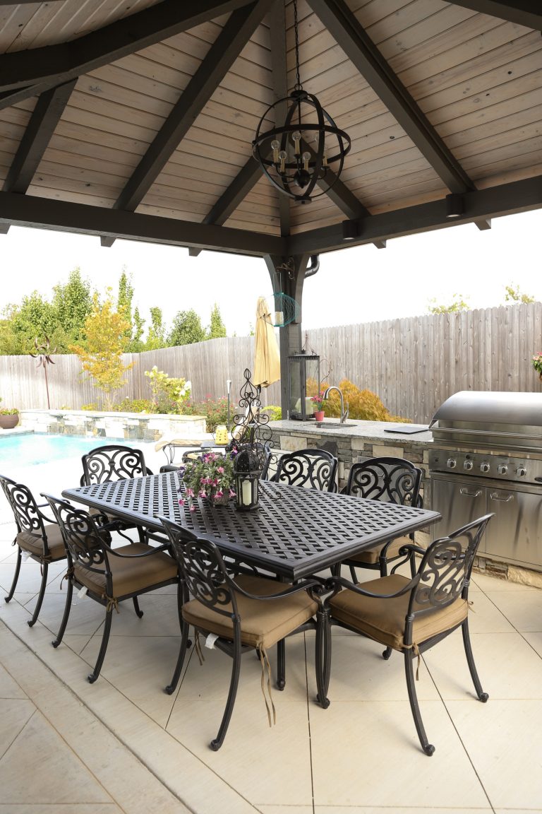 Example of a large transitional backyard tile patio kitchen design in Other with a gazebo