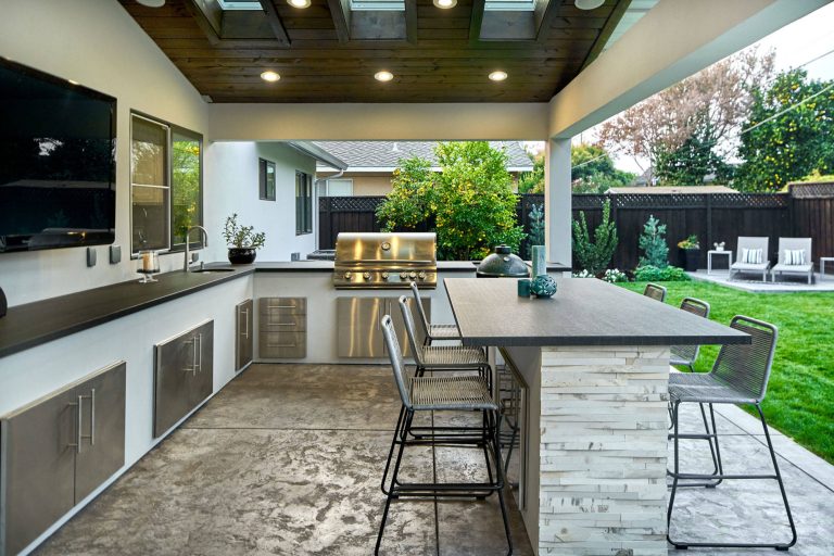 Example of a large trendy backyard concrete patio kitchen design in San Francisco with a roof extension