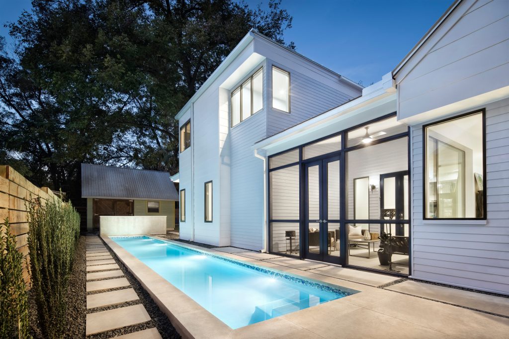 Example of a large trendy backyard concrete paver and rectangular lap pool design in Austin