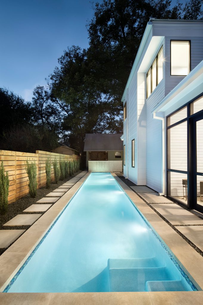 Example of a large trendy backyard concrete paver and rectangular lap pool design in Austin