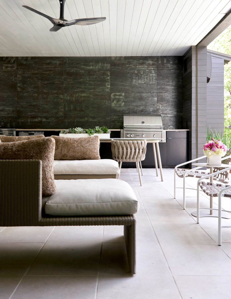 Example of a large trendy backyard concrete paver patio kitchen design in Dallas with a roof extension