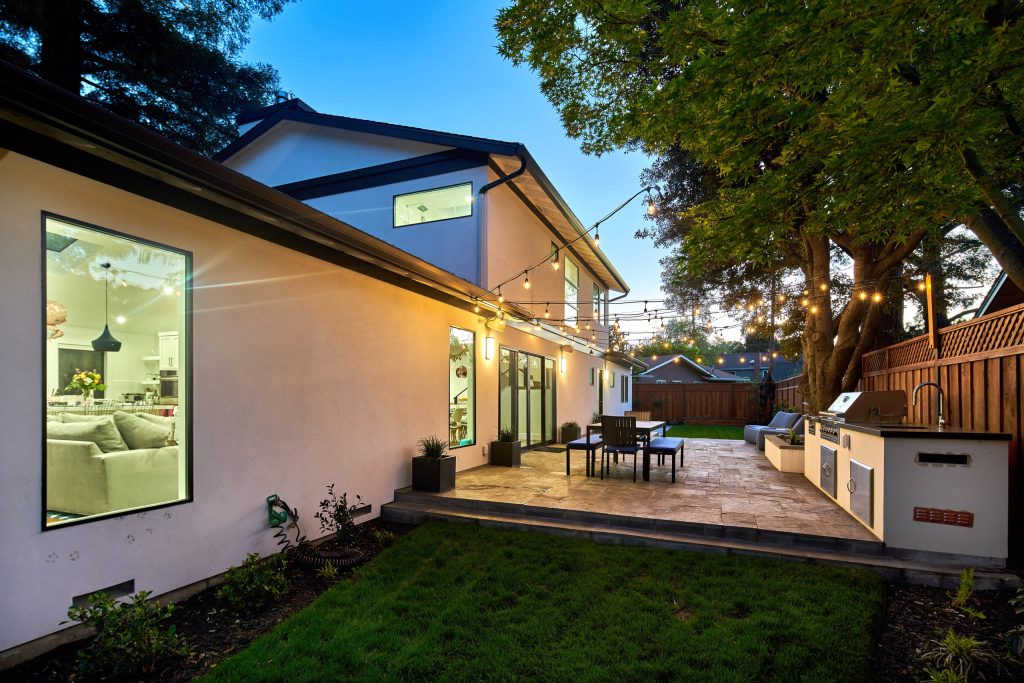 Example of a large trendy backyard concrete paver patio kitchen design in San Francisco with no cover