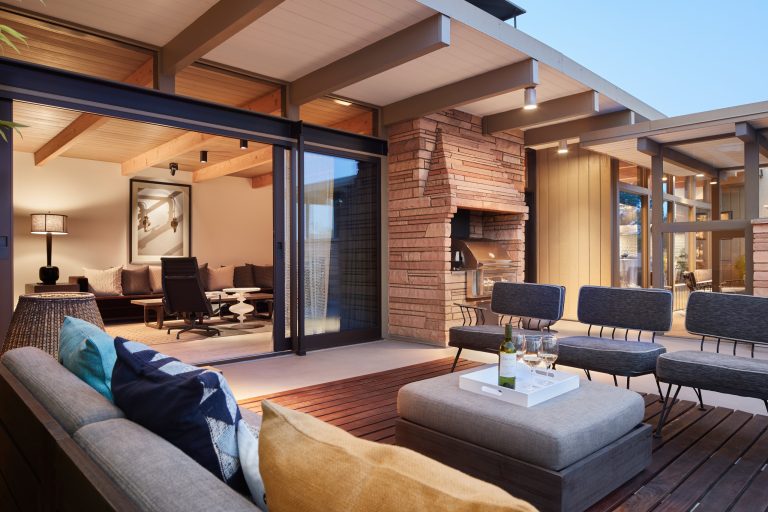 Example of a large trendy backyard outdoor kitchen deck design in Seattle with a roof extension