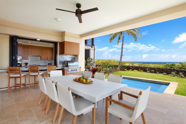 Example of a large trendy backyard patio kitchen design in Hawaii with a roof extension