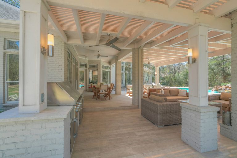 Example of a large trendy backyard patio kitchen design in Houston with decking and a roof extension