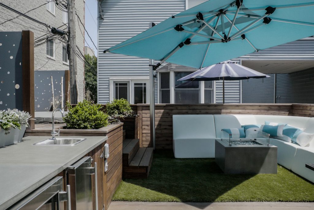 Example of a large trendy backyard patio kitchen design in Orange County with decking and no cover