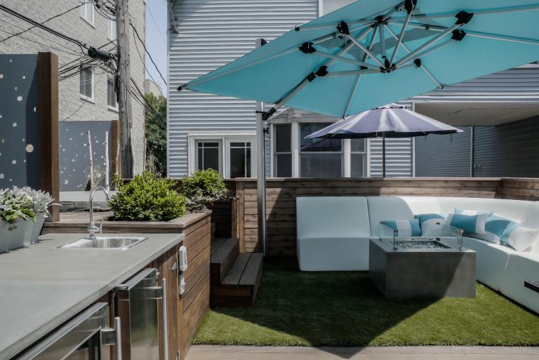 Example of a large trendy backyard patio kitchen design in Orange County with decking and no cover