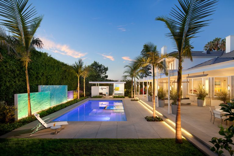 Example of a large trendy backyard rectangular and concrete paver lap pool design in Los Angeles