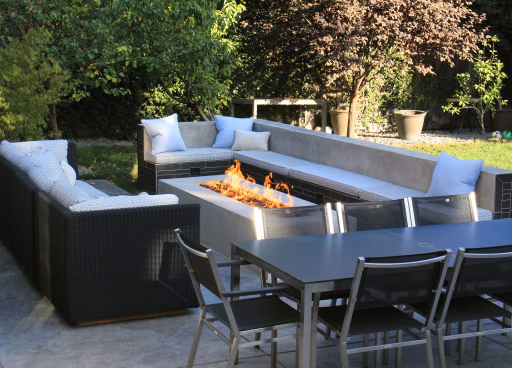 Example of a large trendy backyard stamped concrete patio kitchen design in San Francisco with no cover