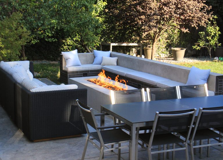 Example of a large trendy backyard stamped concrete patio kitchen design in San Francisco with no cover