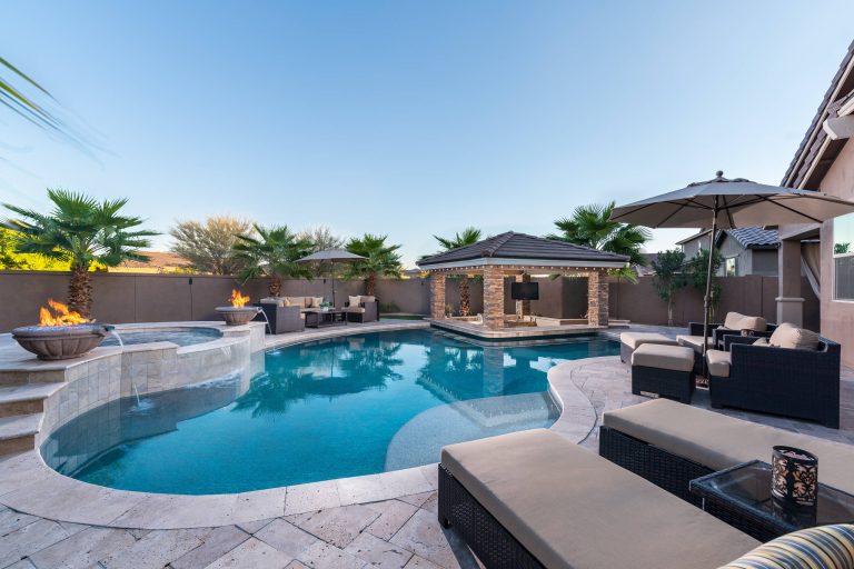 Example of a large trendy backyard stone and custom-shaped hot tub design in Phoenix