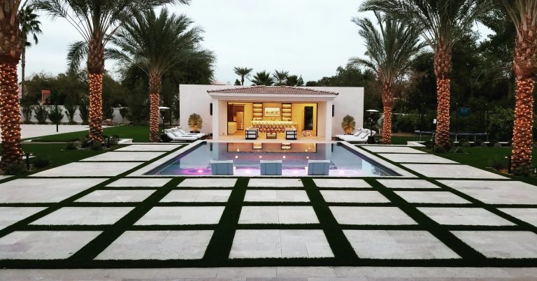 Example of a large trendy backyard stone and rectangular lap pool house design in Phoenix