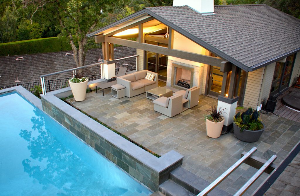 Example of a large trendy backyard stone and rectangular lap pool house design in San Francisco