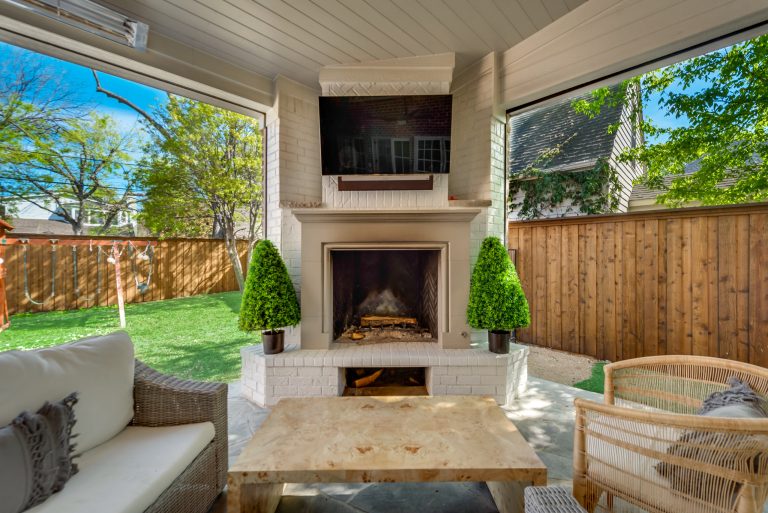 Example of a large trendy backyard stone patio kitchen design in Dallas with a roof extension
