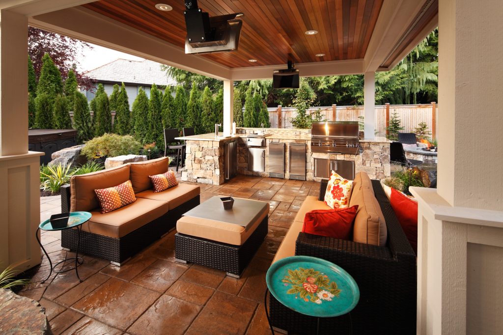 Example of a large trendy backyard stone patio kitchen design in Seattle with a gazebo