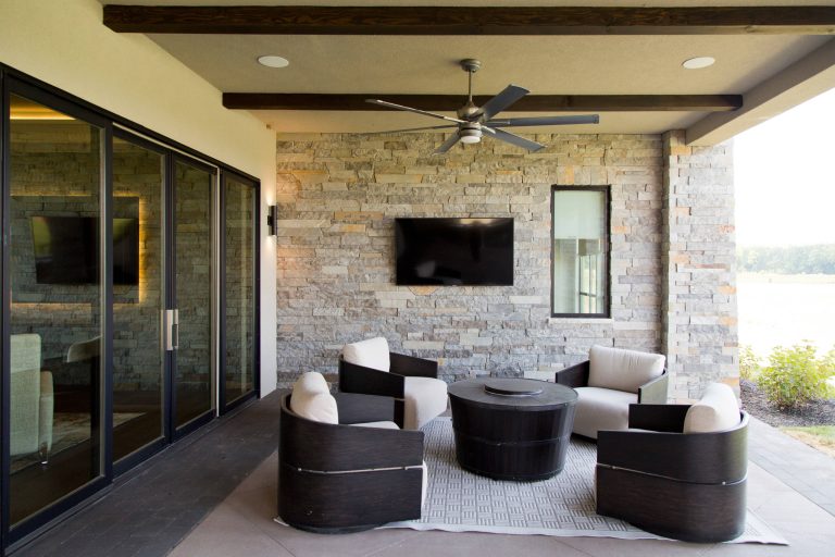 Example of a large trendy backyard tile patio kitchen design in Kansas City with a roof extension