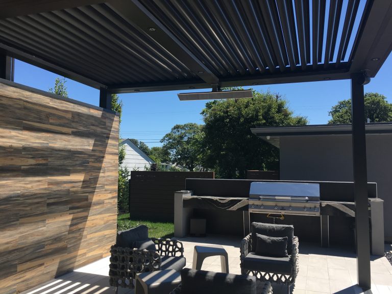 Example of a large trendy backyard tile patio kitchen design in New York with a pergola