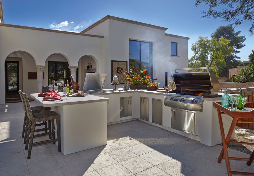 Example of a large trendy backyard tile patio kitchen design in Phoenix with no cover