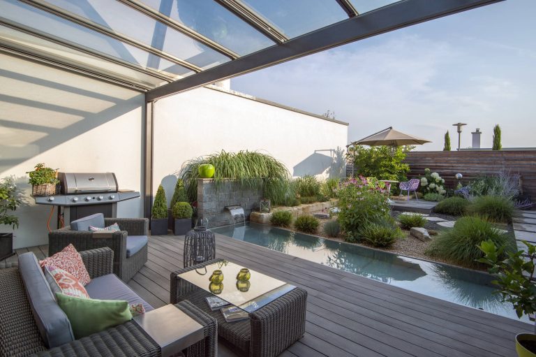 Example of a large trendy outdoor kitchen deck design in Munich with a pergola