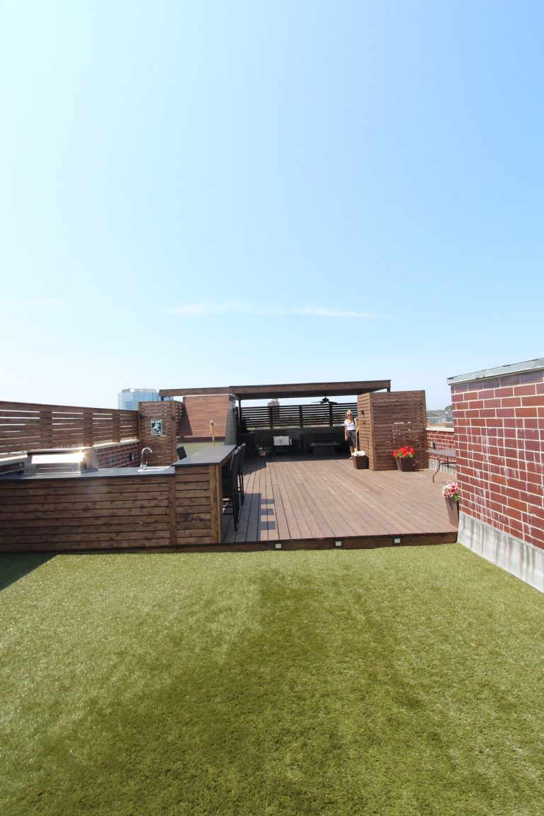 Example of a large trendy rooftop outdoor kitchen deck design in Chicago with a pergola