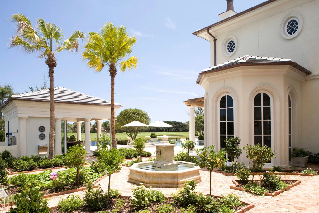 Example of a large tuscan backyard patio kitchen design in Jacksonville with a gazebo